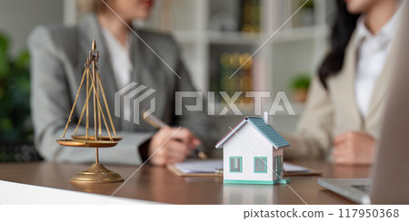 Diverse female lawyers discussing real estate contract details 117950368