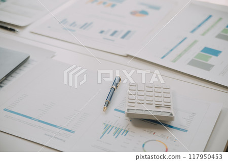 Financial analysts analyze business financial reports on a digital tablet planning investment project during a discussion at a meeting of corporate showing the results of their successful teamwork. Financial analysts analyze business financial reports on a digital tablet planning investment project during a discussion at a meeting of corporate showing the results of their successful teamwork. 117950453