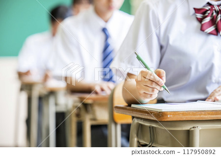 Hands of a female high school student taking a class Hands of a female high school student taking a class 117950892