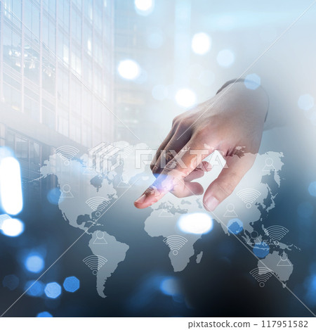 A hand is pointing at a map of the world 117951582