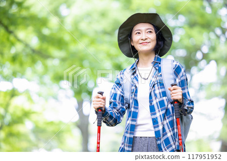 Middle-aged woman enjoying hiking 117951952