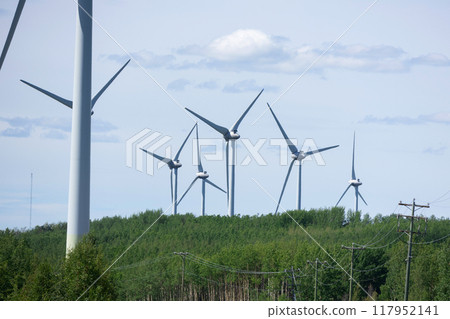 Windmills making green energy in the forest on the mountain. Windmills making green energy in the forest on the mountain. 117952141