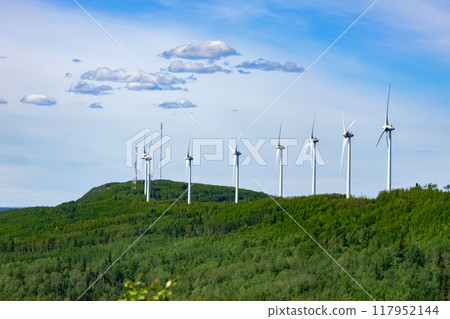Windmills making green energy in the forest on the mountain. 117952144