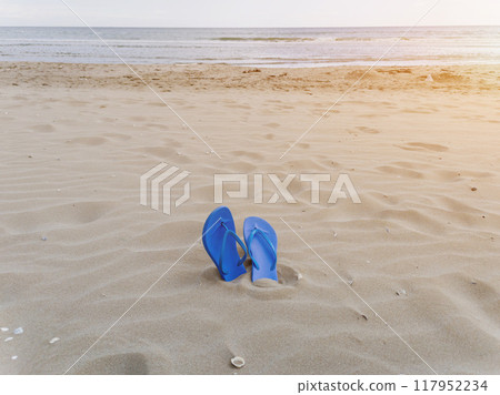 Slippers from a sand on a beach 117952234