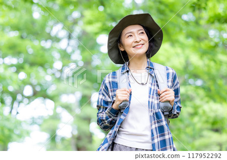 Middle-aged woman enjoying hiking Middle-aged woman enjoying hiking 117952292
