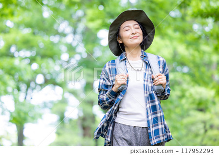 Middle-aged woman enjoying hiking Middle-aged woman enjoying hiking 117952293