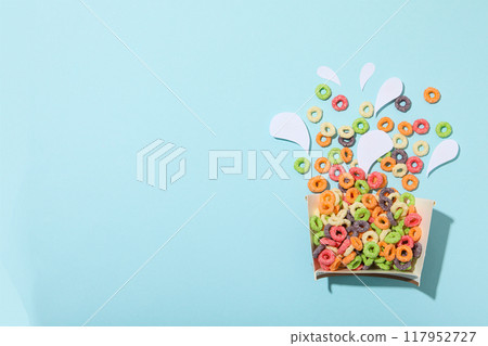 Colorful cornflakes, concept of tasty breakfast, morning food, space for text 117952727