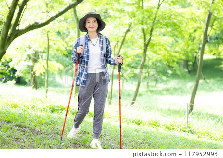 Middle-aged woman enjoying hiking Middle-aged woman enjoying hiking 117952993