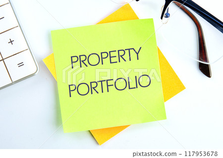 Business Property portfolio concept. Copy space. PROPERTY PORTFOLIO on a light green sticker on a light background 117953678