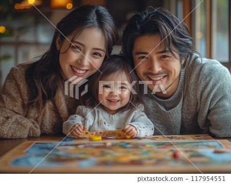 Happy family playing board games together at home, enjoying quality time with smiles and laughter 117954551