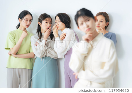 A woman who is worried about being left out of the group A woman who is worried about being left out of the group 117954620