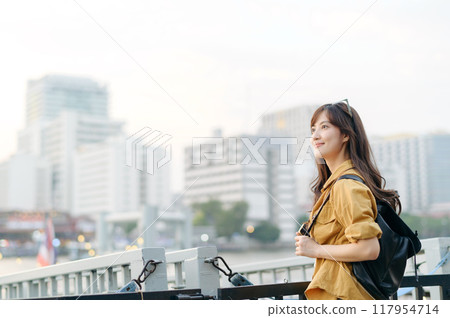 young Asian woman in 30s on a solo adventure. captures the essence of cultural exploration and joyful discovery. young Asian woman in 30s on a solo adventure. captures the essence of cultural exploration and joyful discovery. 117954714