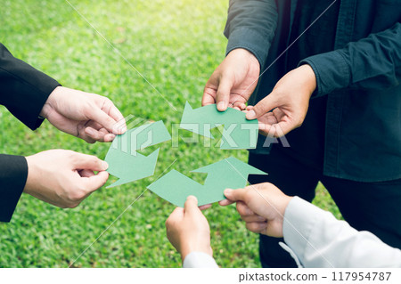 People holding recycle symbol against green spring background. Earth day holiday concept. People holding recycle symbol against green spring background. Earth day holiday concept. 117954787