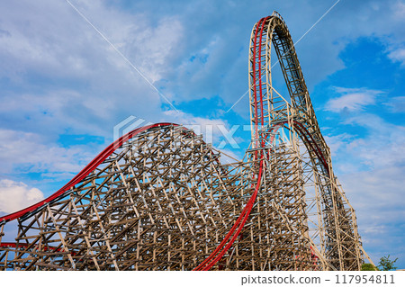 Roller coaster attraction in amusement park. Entertainment at summer holiday 117954811