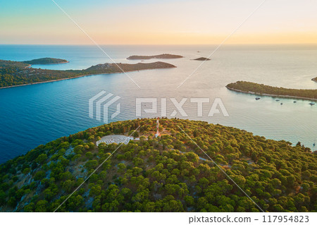 Panoramic view of islands in Adriatic Sea and hedge maze among forest trees at sunset. Lavender labyrinth in Rogoznica, Croatia. Aerial view of coastal landscape. Place for summer vacation Panoramic view of islands in Adriatic Sea and hedge maze among forest trees at sunset. Lavender labyrinth in Rogoznica, Croatia. Aerial view of coastal landscape. Place for summer vacation 117954823