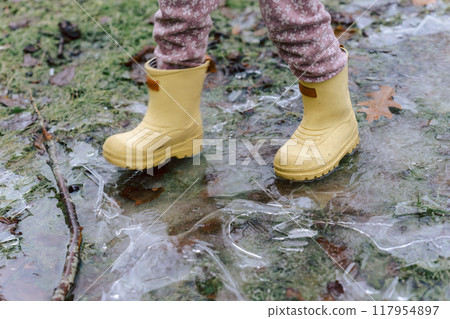 The feet of a child playing outside on a winter day 117954897