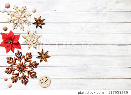 Eco friendly Christmas. Christmas background with retro wooden beads, poinsettia, star anise, snowflake on wooden boards. Copy space for text. Ecology, environmental conservation, zero waste concept 117955289
