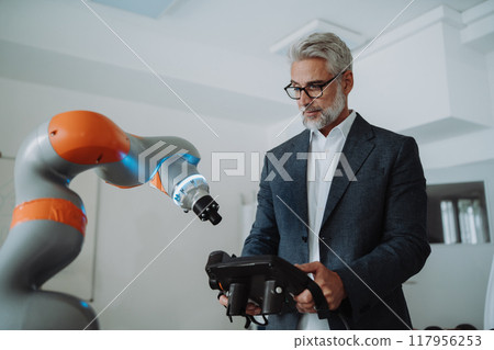 Automation, robotics engineer working on robotic knee replacement surgery project. Concept of modern technology in medicine, automated processes, healthcare. 117956253
