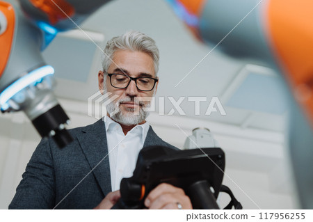 Automation, robotics engineer working on robotic knee replacement surgery project. Concept of modern technology in medicine, automated processes, healthcare. 117956255
