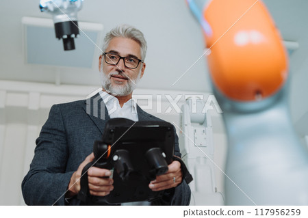 Automation, robotics engineer working on robotic knee replacement surgery project. Concept of modern technology in medicine, automated processes, healthcare. 117956259