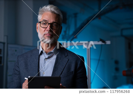 Portrait of robotics engineer holding tablet, standing in laboratory. Concept of modern technology in industries, automated processes, automotive 117956268