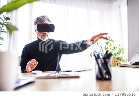 Homeoffice for handsome man with VR headset. Virutal meeting or remote collaboration. 117956516