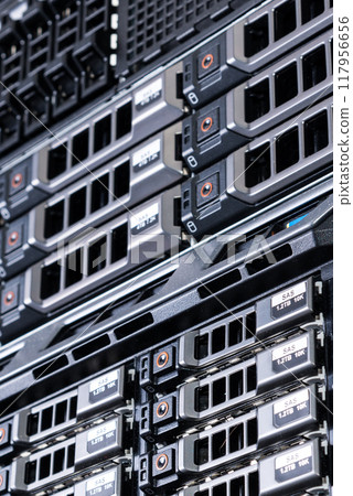Row of hard drives serving as data storage inside server room 117956656