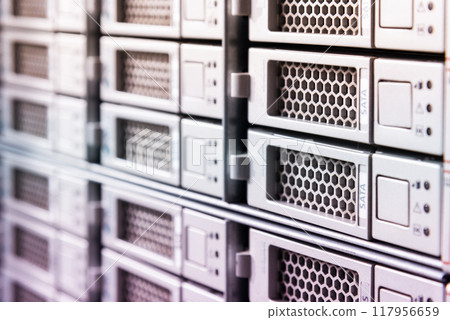 Row of hard drives serving as data storage inside server room 117956659