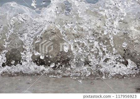 White foam and sea water drop splashes slow motion with sand and blue water White foam and sea water drop splashes slow motion with sand and blue water 117956923