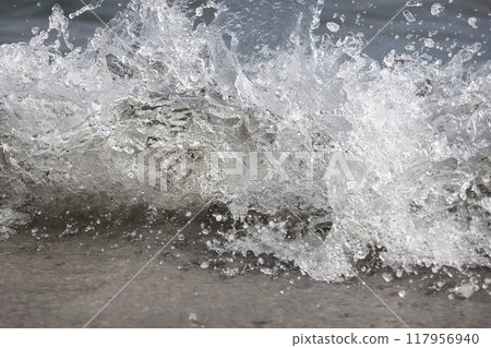 White foam and sea water drop splashes slow motion with sand and blue water White foam and sea water drop splashes slow motion with sand and blue water 117956940