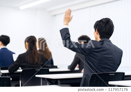 Male and female businessmen receiving training 117957176