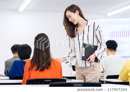 Young men and women receiving a seminar Young men and women receiving a seminar 117957204