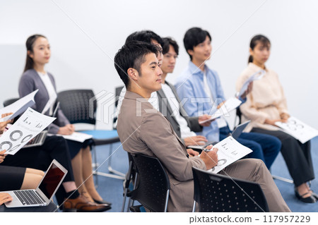 Young men and women receiving a seminar Young men and women receiving a seminar 117957229