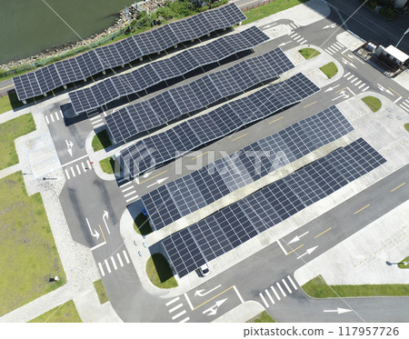 Aerial view above innovative solar panels located on a car parking lot rooftops 117957726