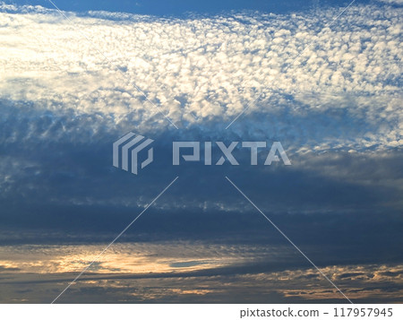 Dark Moody Thunder Clouds Sunset Clouds in a Blue Sky as A Skyscape Background Dark Moody Thunder Clouds Sunset Clouds in a Blue Sky as A Skyscape Background 117957945