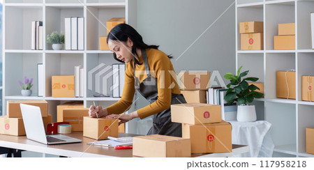 Female entrepreneur labeling packages for ecommerce sales Female entrepreneur labeling packages for ecommerce sales 117958218