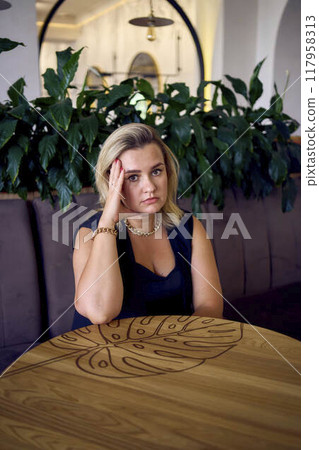 a middle-aged plus size woman in old money style clothes in a fancy restaurant 117958313