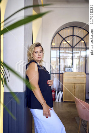 a middle-aged plus size woman in old money style clothes in a fancy restaurant 117958322