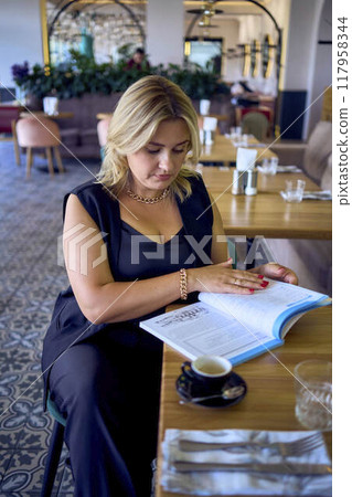 a middle-aged plus size woman in old money style clothes in a fancy restaurant a middle-aged plus size woman in old money style clothes in a fancy restaurant 117958344