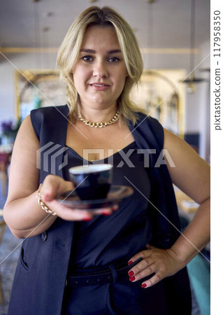 a middle-aged plus size woman in old money style clothes in a fancy restaurant a middle-aged plus size woman in old money style clothes in a fancy restaurant 117958350