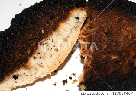 Very Burnt Bread Roll Torn or Cut in Half Toast Close Up Texture 117958407