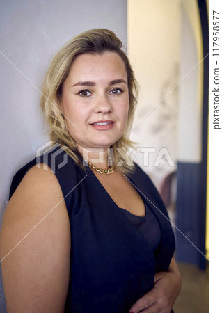 a middle-aged plus size woman in old money style clothes in a fancy restaurant 117958577