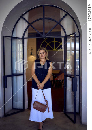 a middle-aged plus size woman in old money style clothes in a fancy restaurant a middle-aged plus size woman in old money style clothes in a fancy restaurant 117958619