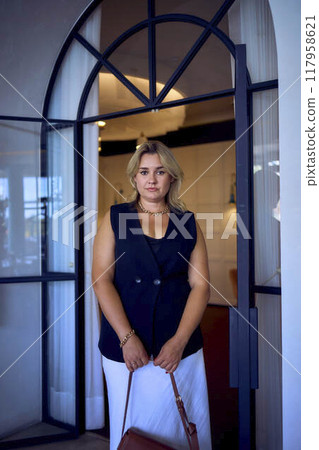 a middle-aged plus size woman in old money style clothes in a fancy restaurant a middle-aged plus size woman in old money style clothes in a fancy restaurant 117958621