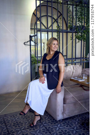a middle-aged plus size woman in old money style clothes in a fancy restaurant a middle-aged plus size woman in old money style clothes in a fancy restaurant 117958744