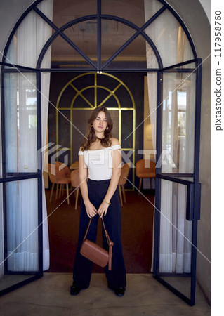 16-year-old teenage girl in old money style clothes in a fancy restaurant 16-year-old teenage girl in old money style clothes in a fancy restaurant 117958760