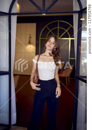 16-year-old teenage girl in old money style clothes in a fancy restaurant 117958766