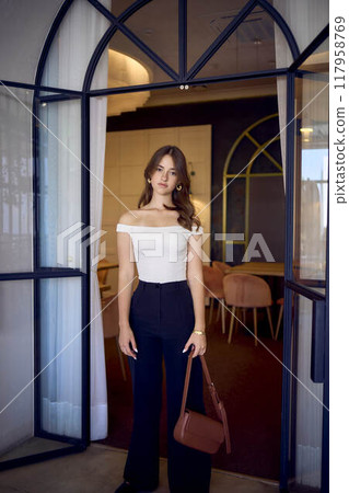 16-year-old teenage girl in old money style clothes in a fancy restaurant 16-year-old teenage girl in old money style clothes in a fancy restaurant 117958769