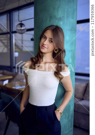 a 16-year-old teenage girl in old money style clothes in  fancy restaurant 117959366