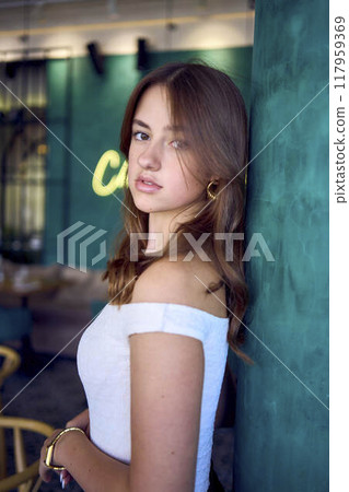 a 16-year-old teenage girl in old money style clothes in  fancy restaurant 117959369